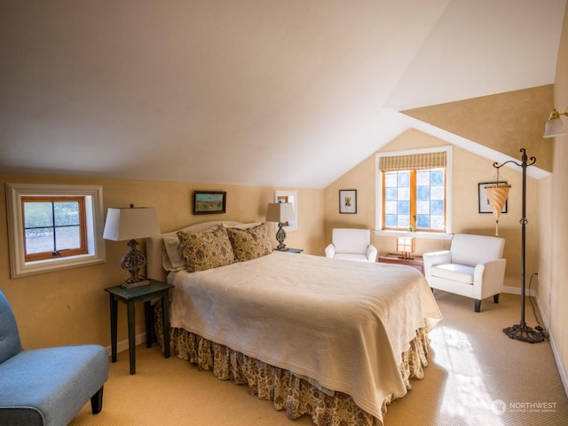 bedroom with light colored carpet, lofted ceiling, and multiple windows