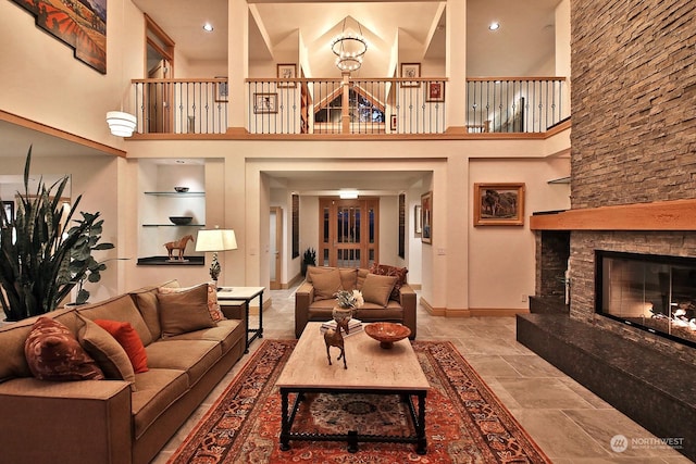 living room with a towering ceiling and a fireplace