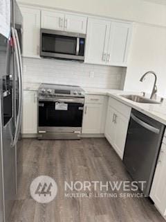 kitchen featuring white cabinetry, sink, and stainless steel appliances