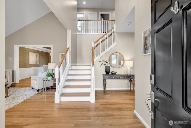 entrance foyer featuring a high ceiling and light hardwood / wood-style flooring