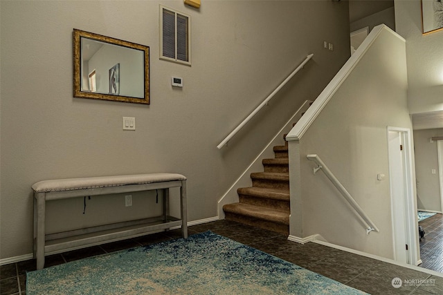 stairway featuring tile patterned floors