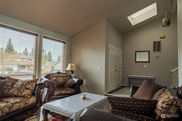 living room with lofted ceiling with skylight