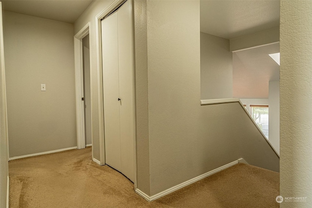 hallway with light colored carpet