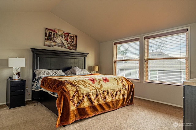 carpeted bedroom featuring lofted ceiling