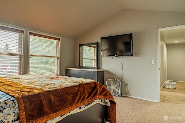 carpeted bedroom featuring lofted ceiling