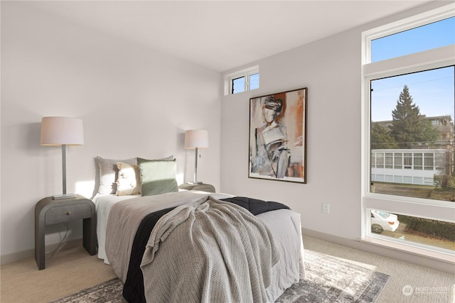 bedroom featuring carpet and baseboards