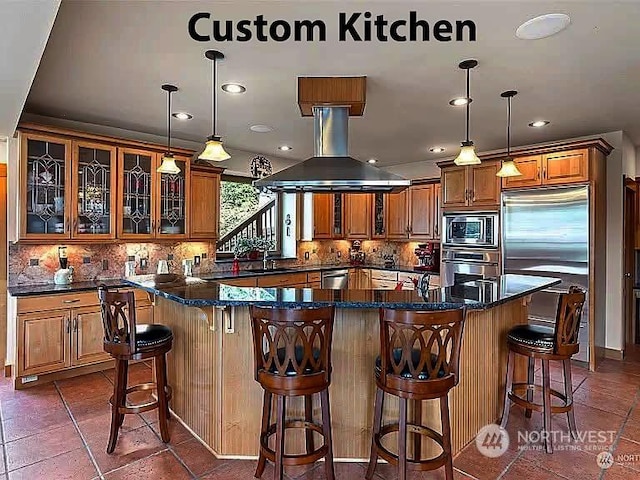 kitchen with tasteful backsplash, island range hood, built in appliances, and decorative light fixtures