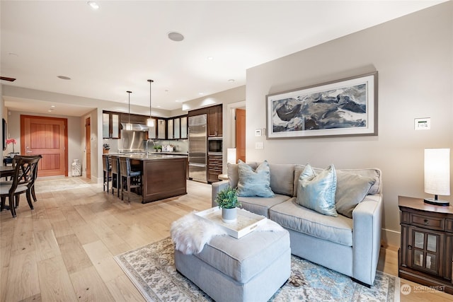 living room with sink and light hardwood / wood-style floors