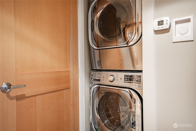 washroom featuring stacked washer / drying machine