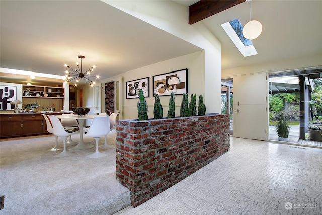 interior space featuring an inviting chandelier and a skylight