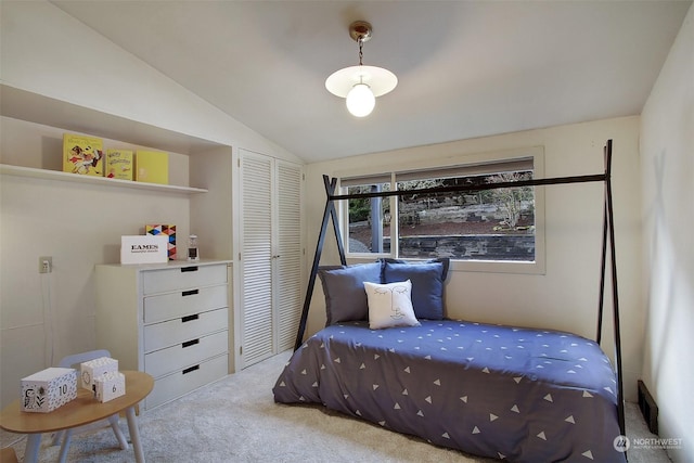 bedroom featuring a closet, vaulted ceiling, and light carpet