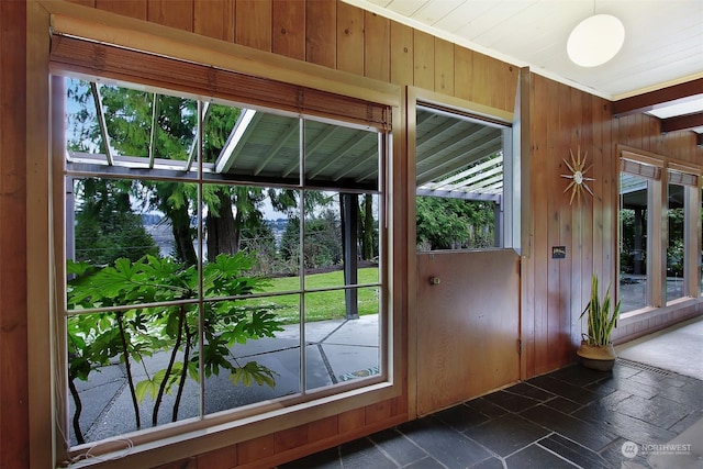 doorway featuring wood walls