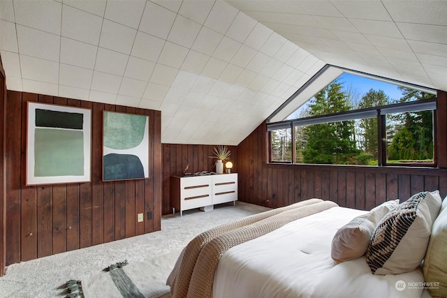 carpeted bedroom featuring lofted ceiling and wooden walls