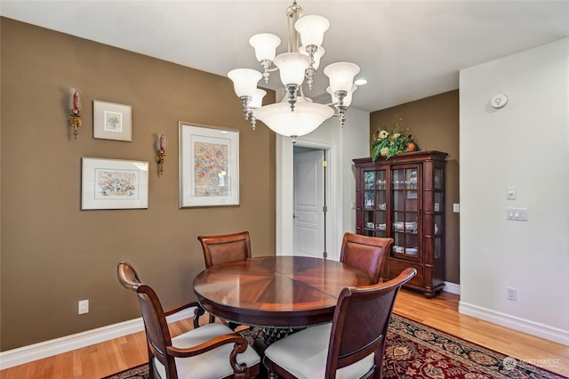 dining room with an inviting chandelier and hardwood / wood-style floors