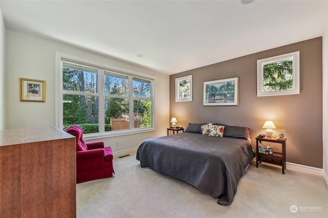 bedroom featuring light carpet