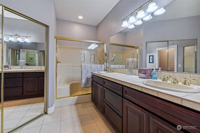 bathroom featuring vanity, tile patterned floors, and a shower with shower door