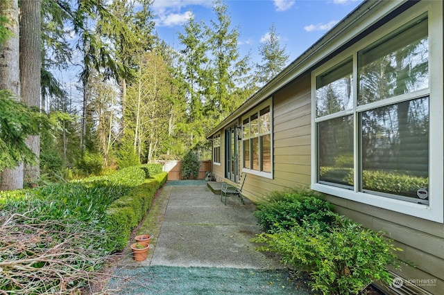 view of side of home with a patio