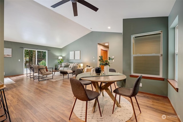 dining area featuring lofted ceiling and light hardwood / wood-style floors