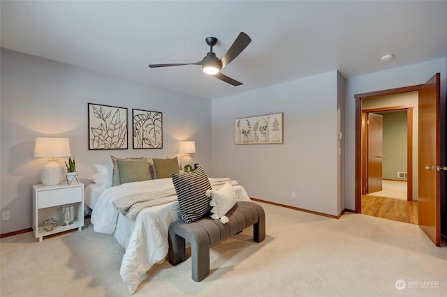 bedroom featuring ceiling fan and light colored carpet