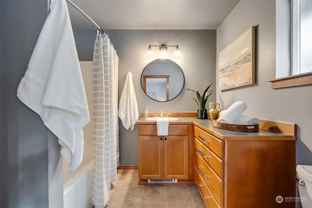 full bathroom with shower / tub combo with curtain, vanity, tile patterned flooring, and toilet