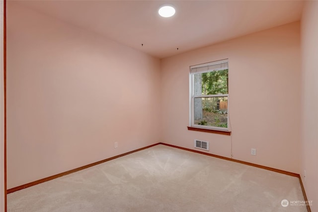 unfurnished room featuring light colored carpet