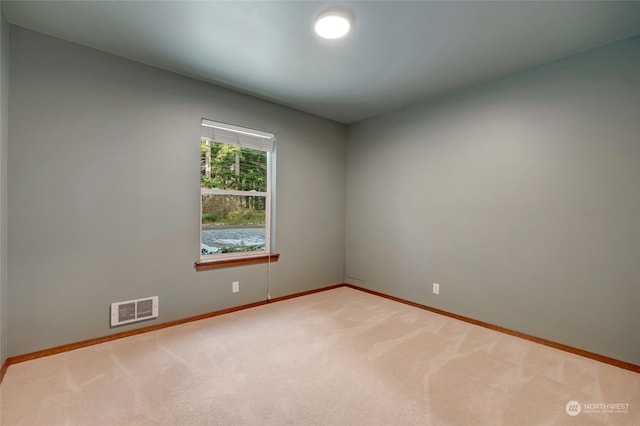 unfurnished room featuring light colored carpet