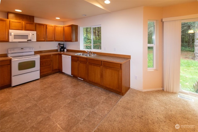 kitchen featuring white appliances and sink