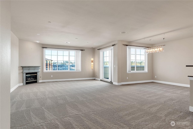 unfurnished living room featuring light colored carpet and a notable chandelier