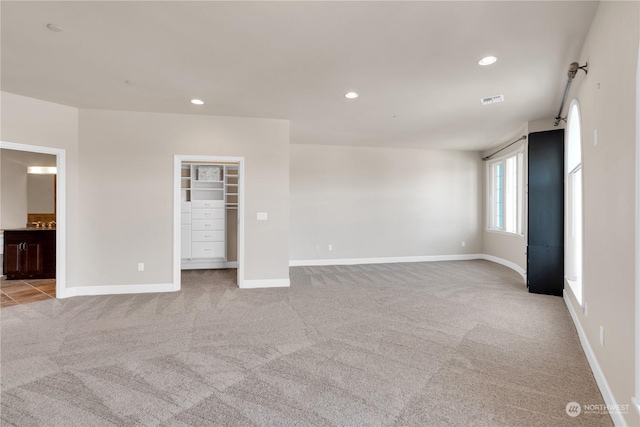 unfurnished room with light carpet