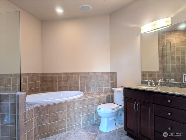 bathroom with vanity, toilet, tile patterned flooring, and tiled tub