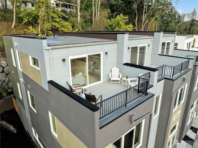 back of house featuring a balcony