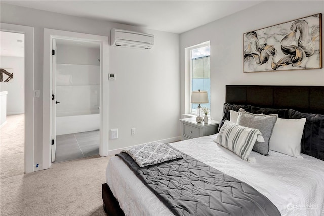 carpeted bedroom featuring ensuite bath and a wall mounted air conditioner