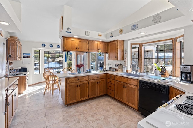 kitchen featuring kitchen peninsula, lofted ceiling, sink, dishwasher, and light tile patterned floors