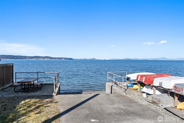 view of dock with a water and mountain view