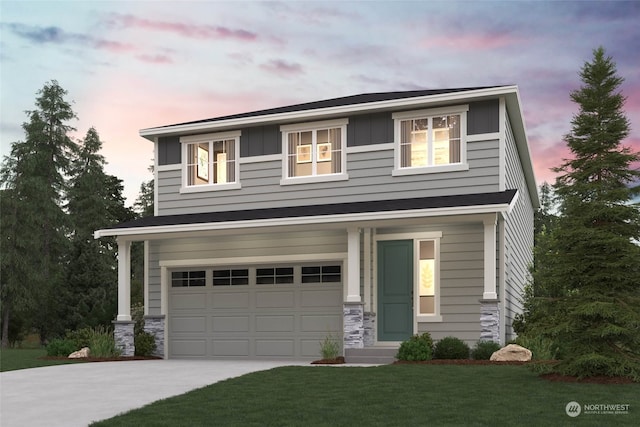 view of front of house with a garage and a lawn