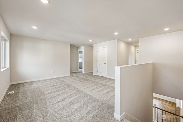 unfurnished room featuring light colored carpet