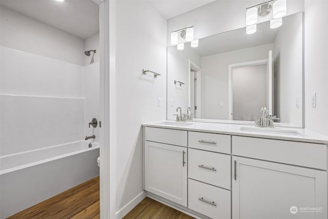 bathroom featuring vanity, hardwood / wood-style floors, and shower / bathtub combination