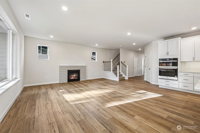 unfurnished living room with light hardwood / wood-style floors