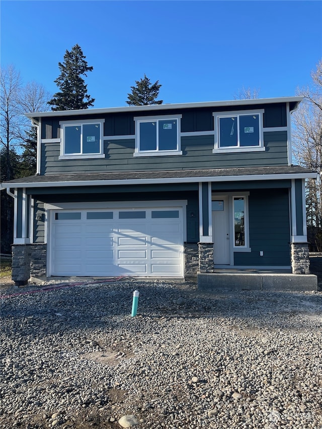 view of front of home featuring a garage and a porch