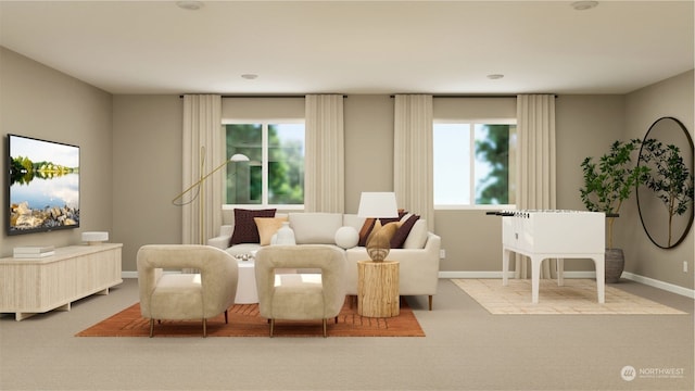 sitting room featuring a wealth of natural light and light colored carpet