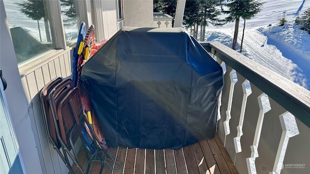 snow covered deck featuring a grill