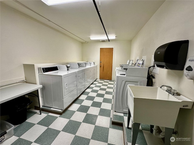 laundry area featuring sink and washer and clothes dryer