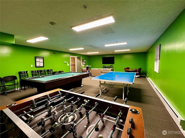 recreation room with baseboard heating and a textured ceiling