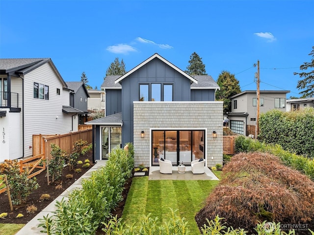 rear view of house featuring a yard and a patio area