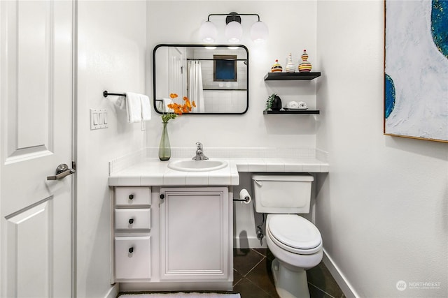 bathroom with vanity, tile patterned floors, and toilet