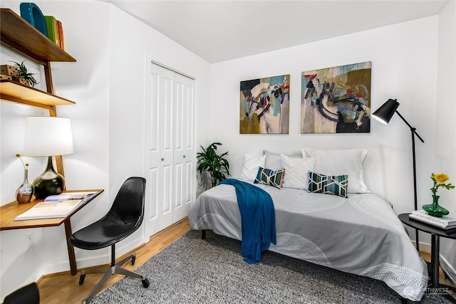 bedroom with hardwood / wood-style floors and a closet