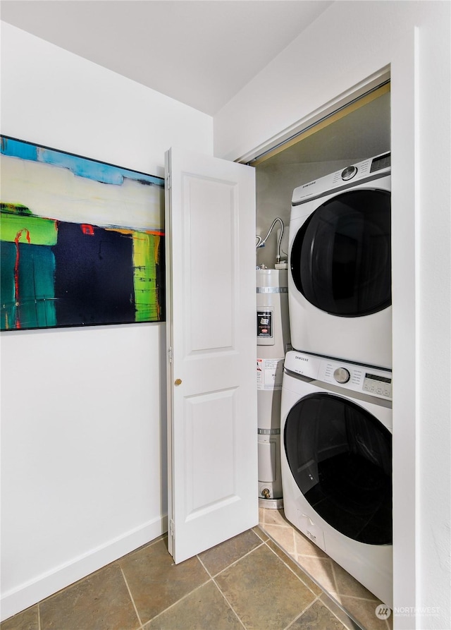 clothes washing area featuring laundry area, strapped water heater, stacked washer / dryer, and tile patterned floors