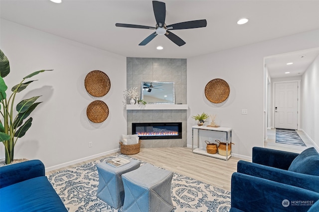 living room with hardwood / wood-style floors and a tile fireplace