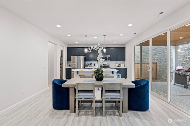 dining space with light hardwood / wood-style floors