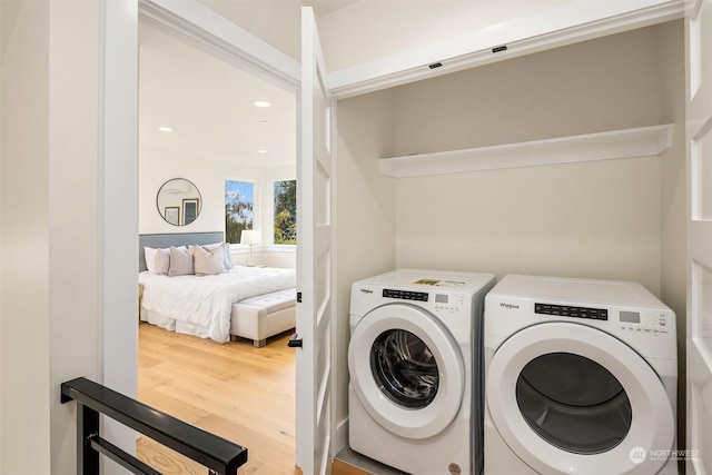 laundry area with hardwood / wood-style flooring and separate washer and dryer